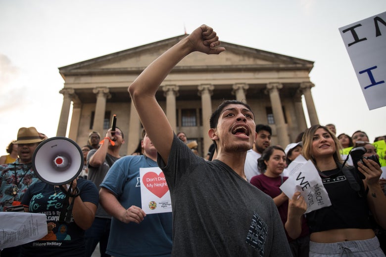Activists with signs and megaphones rally outside the Tennessee state Capitol.